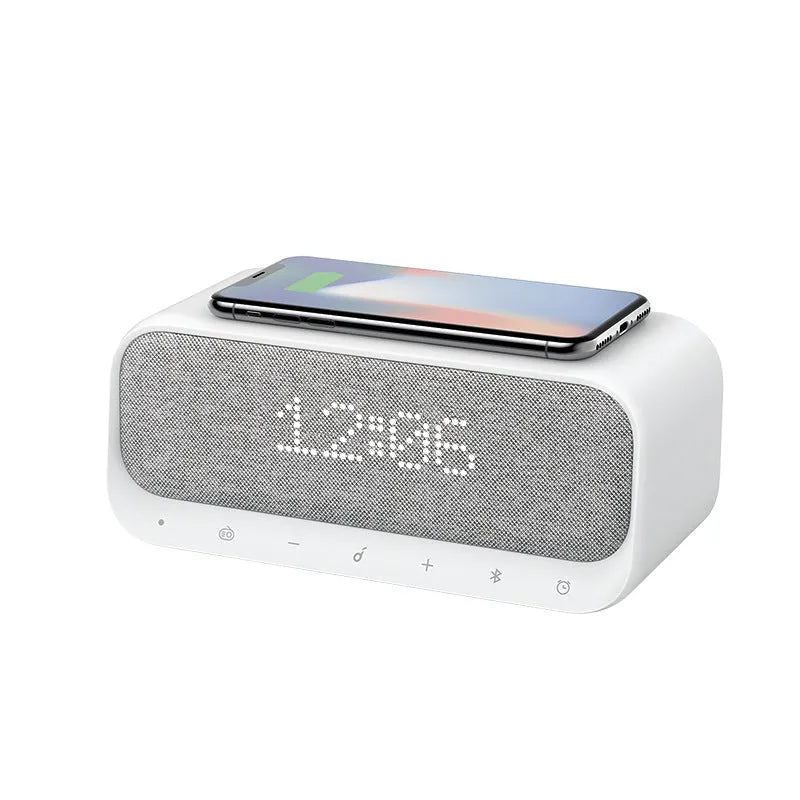 White Soundcore Bluetooth speaker with wireless charging top and digital display.