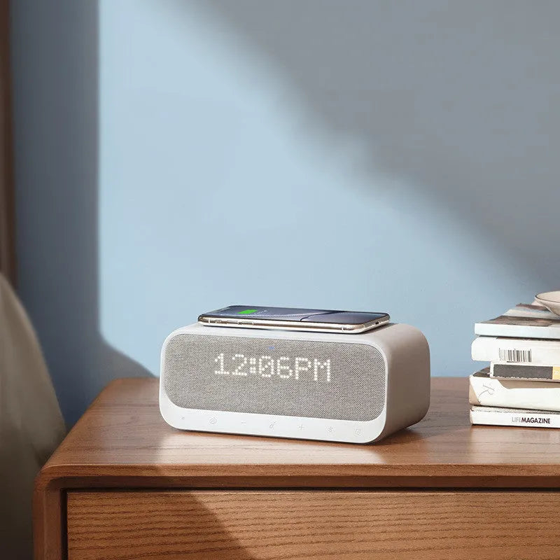 White Soundcore Bluetooth speaker with wireless charging top and digital display.