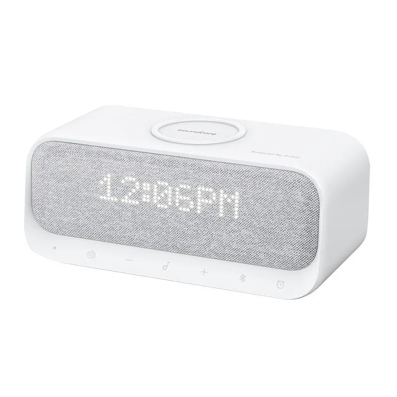 White Soundcore Bluetooth speaker with wireless charging top and digital display.
