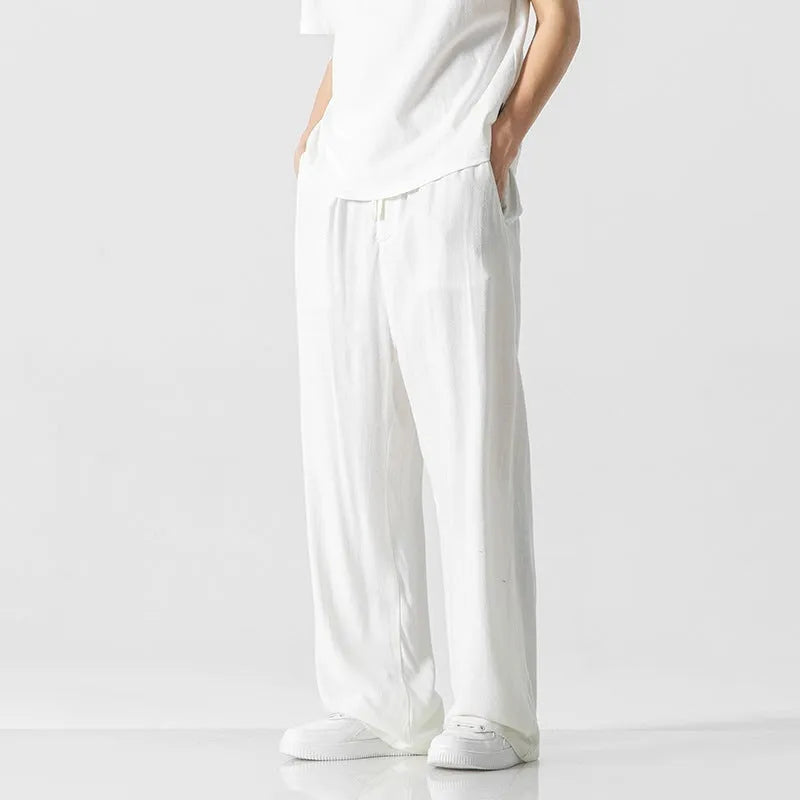 Men's beige linen casual trousers with a loose straight-leg fit and drawstring waist.