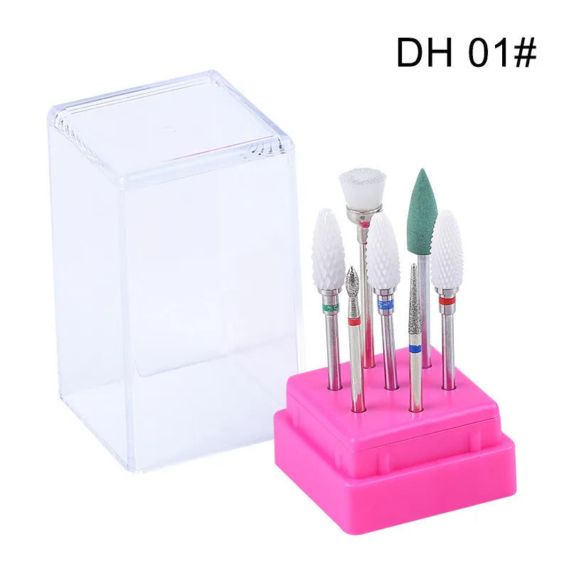 Set of seven tungsten steel nail drill bits and a brush in a transparent storage case.