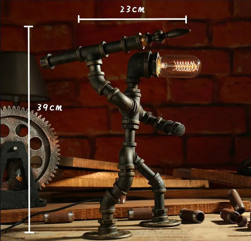 Green bronze vintage industrial robot desk lamp with iron pipe design on a wooden table.