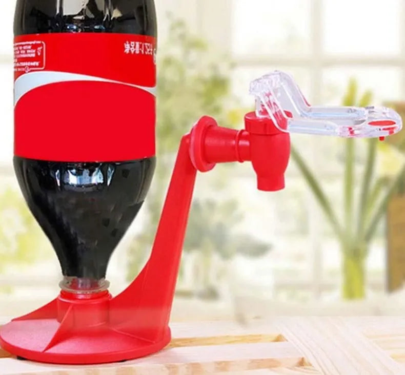 Red plastic soda dispenser attached to inverted 2-litre bottle for push-button drink serving