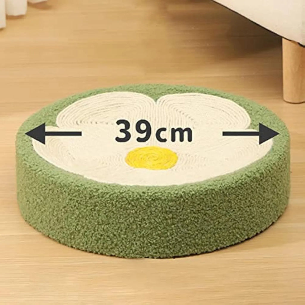 Green round sisal cat scratcher bowl lounge bed for kittens on a floor.
