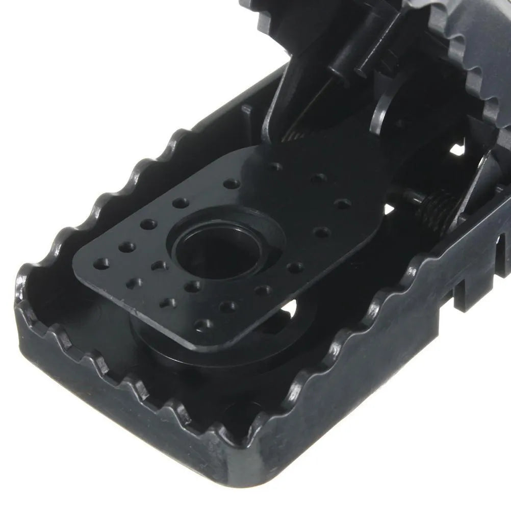 Six black plastic snap-action mousetraps showing their size and smooth surface.