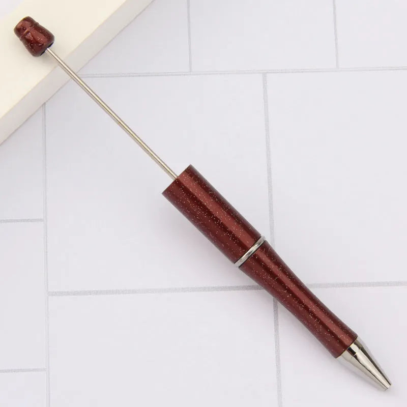 Creative ballpoint pen with multicoloured spinning plastic beads on a steel wire frame.