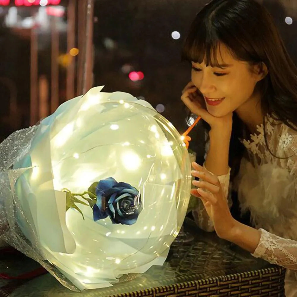 Transparent LED luminous balloon bouquet with artificial rose and glowing light inside, displayed as a DIY kit.