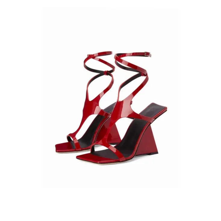 Women's black high heel sandals with square toe and ankle strap button fastening on a white background.