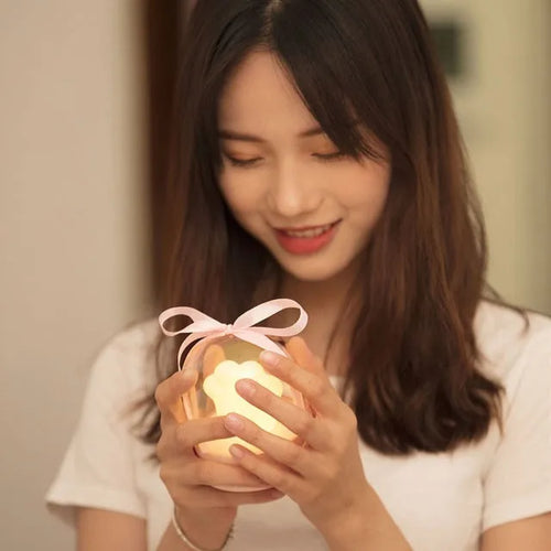 Grey and pink cat paw shaped USB rechargeable night light with adjustable brightness and musical rotation features