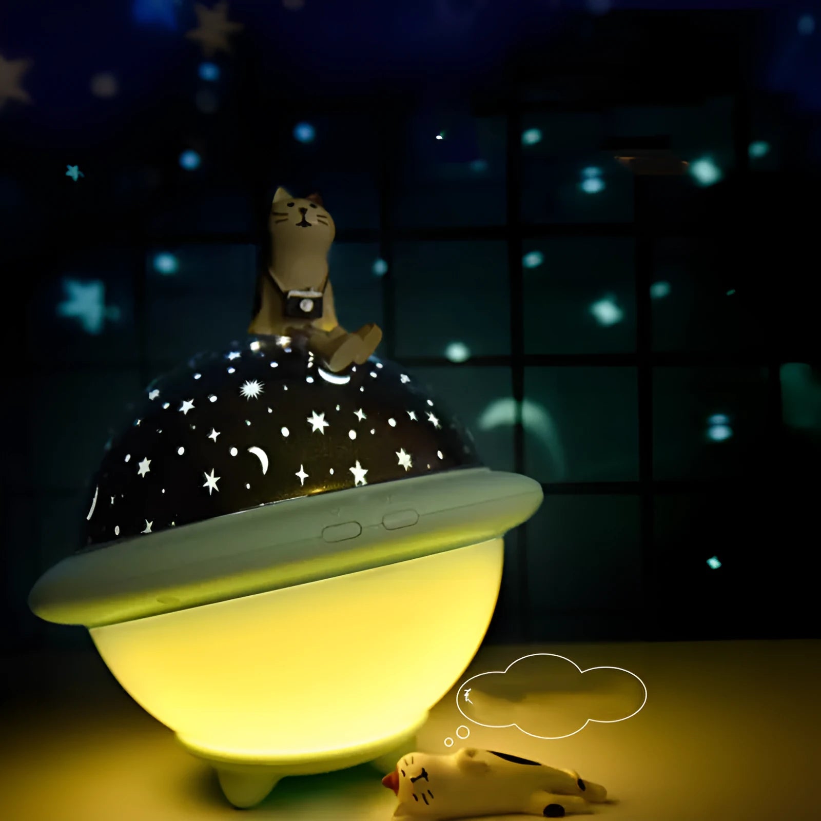 Green UFO-shaped starry sky projection night light on a table, showing rotating planet display on wall.