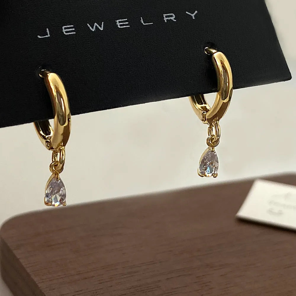 Women's zircon jewellery set with geometric meteor shower necklace, matching earrings, and anklet.