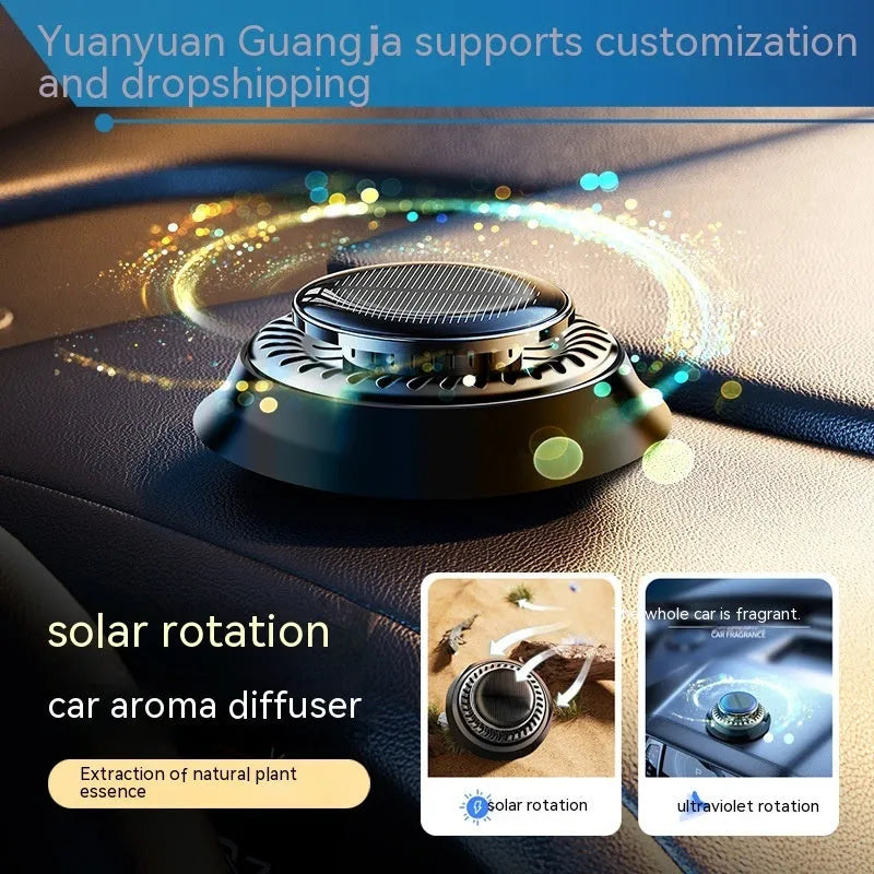 Solar-powered kinetic car air freshener with rotating double rings on car dashboard