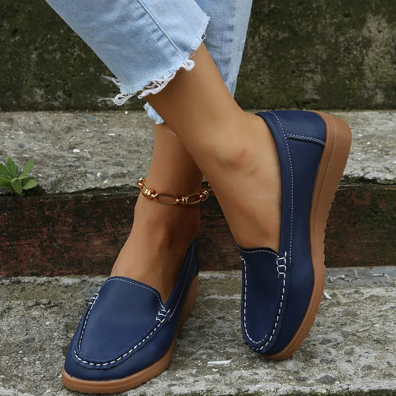 Women's PU leather flats loafers in round toe design with car suture detailing on upper