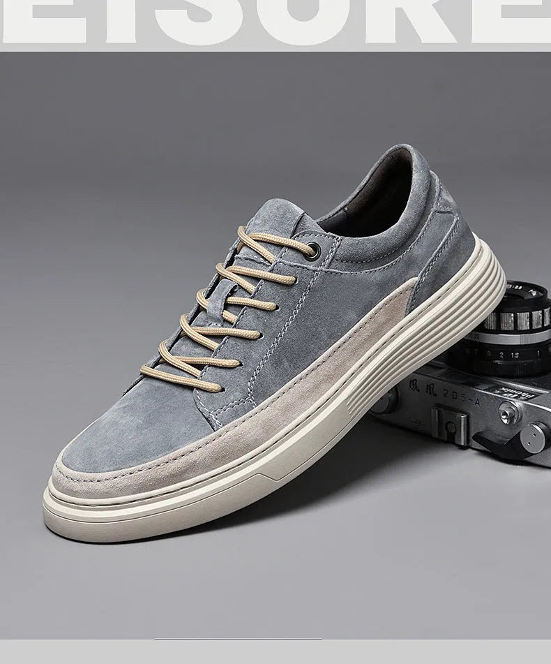 Men's gray casual skate shoes with pigskin leather upper and rubber sole on a white background.