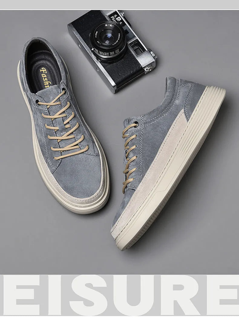 Men's gray casual skate shoes with pigskin leather upper and rubber sole on a white background.