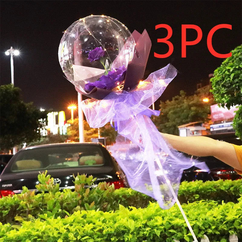 Transparent LED luminous balloon bouquet with artificial rose and glowing light inside, displayed as a DIY kit.