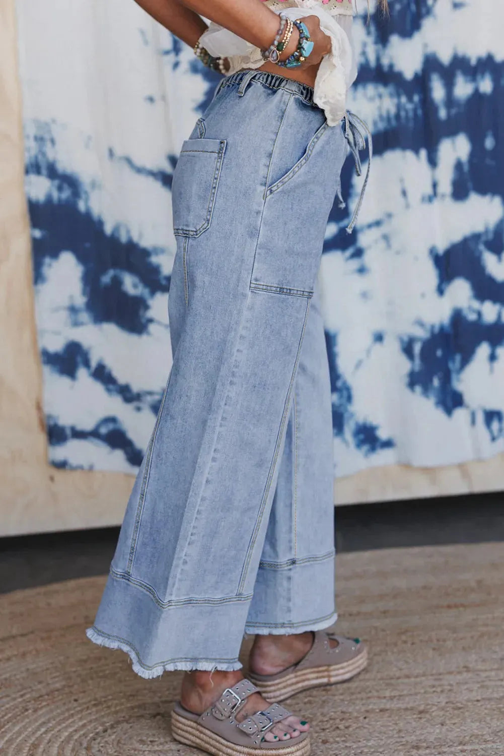 Beau Blue women's wide leg denim pants with drawstring waist and raw hem detailing.
