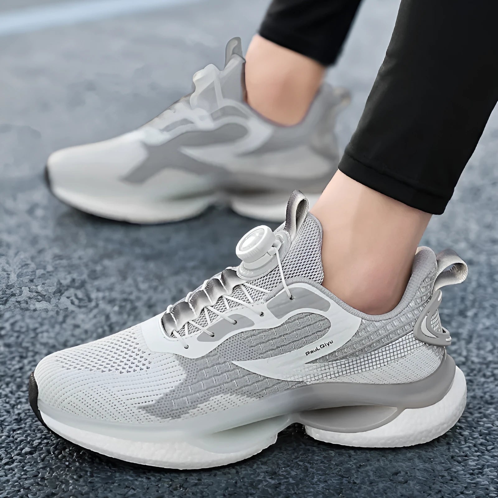 Men's low-top running shoes with rotating button buckle on beige Fly-kit mesh upper and TPU sole.