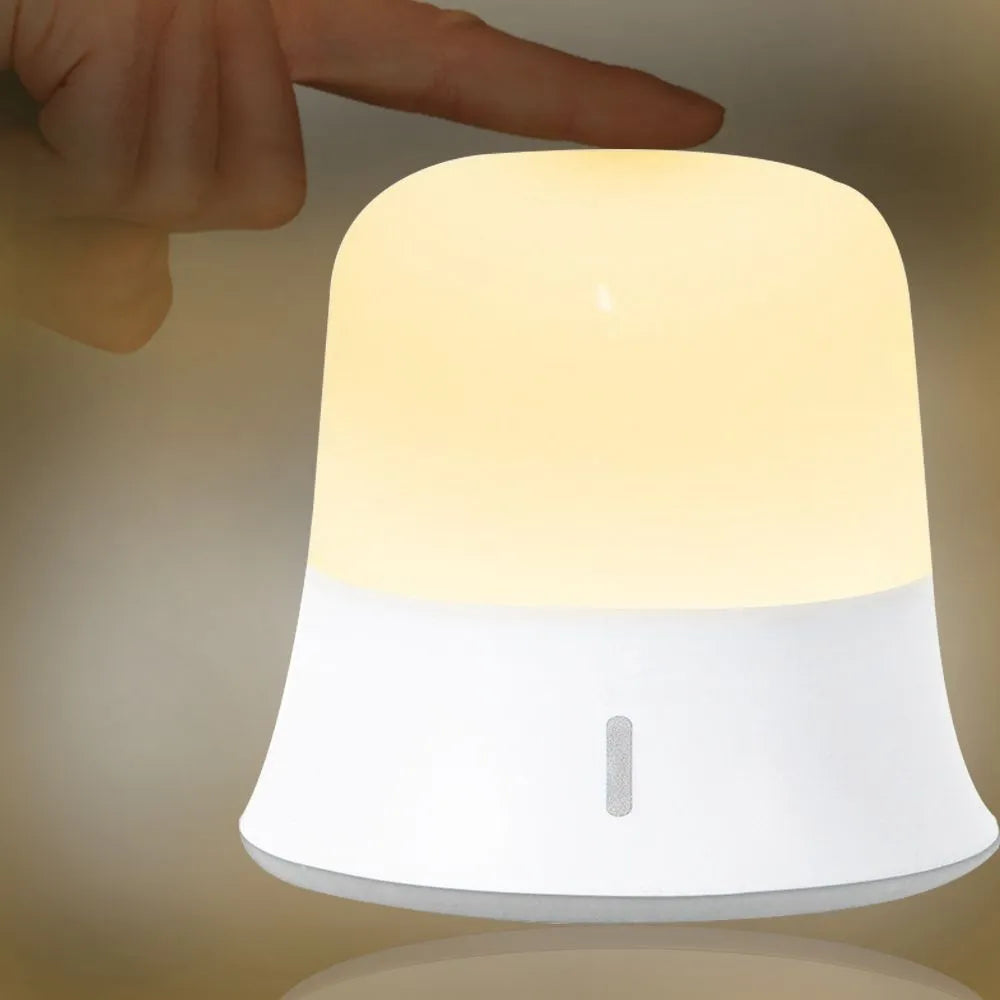 White touch-control bedside night light with rechargeable battery shown next to a USB cable.