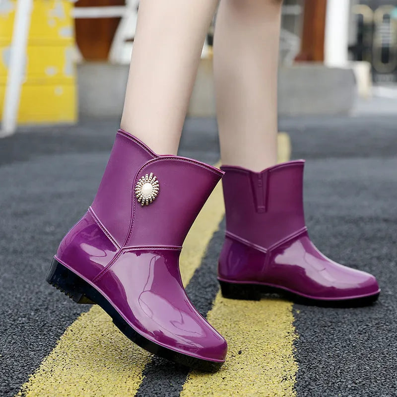 Women's purple rain boot with middle tube height and textured non-slip sole.