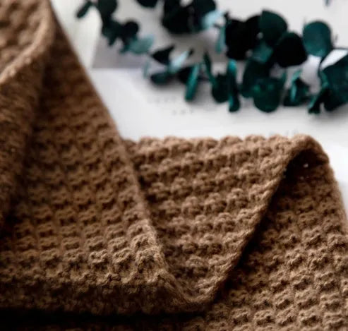 Nordic fringed knit ball acrylic blanket in beige colour, laid flat showing 130x170cm size and fringe detail