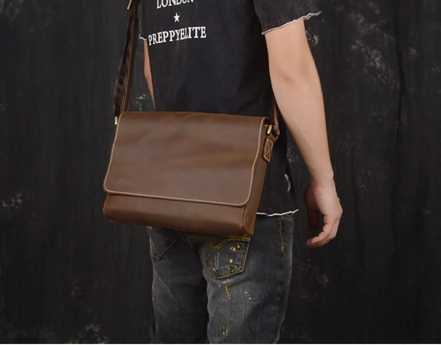 Brown vintage leather men's messenger bag with a flap opening and an adjustable shoulder strap.