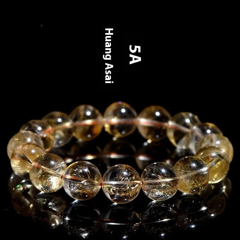 A natural yellow citrine beaded bracelet with geometric stones on a wrist, showing single circle design.