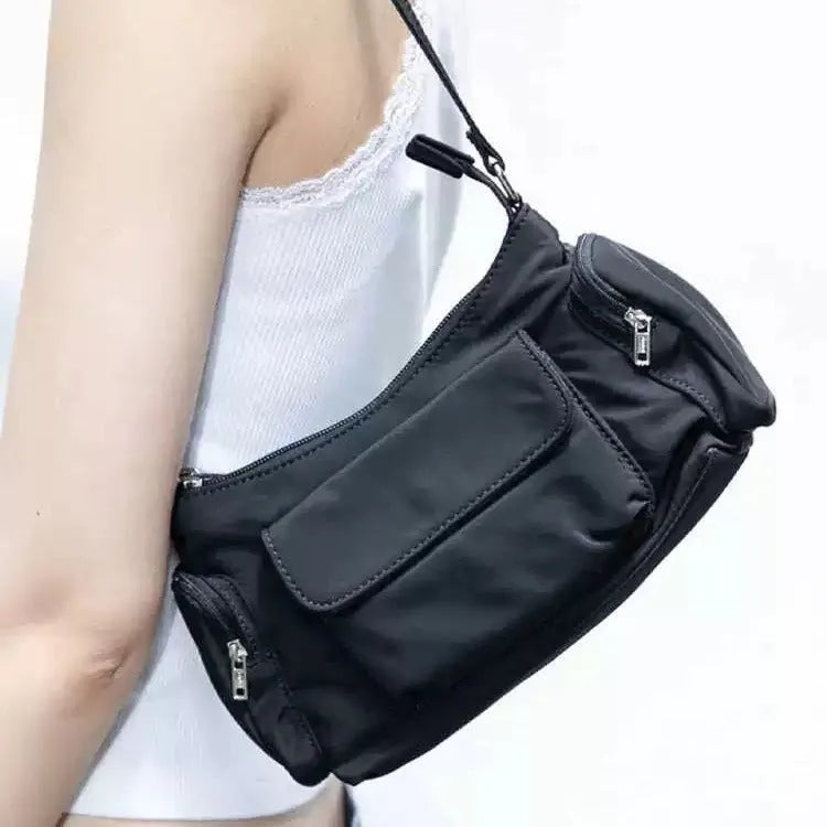 Simple black lightweight PU women's shoulder bag with double pockets and side line detail.
