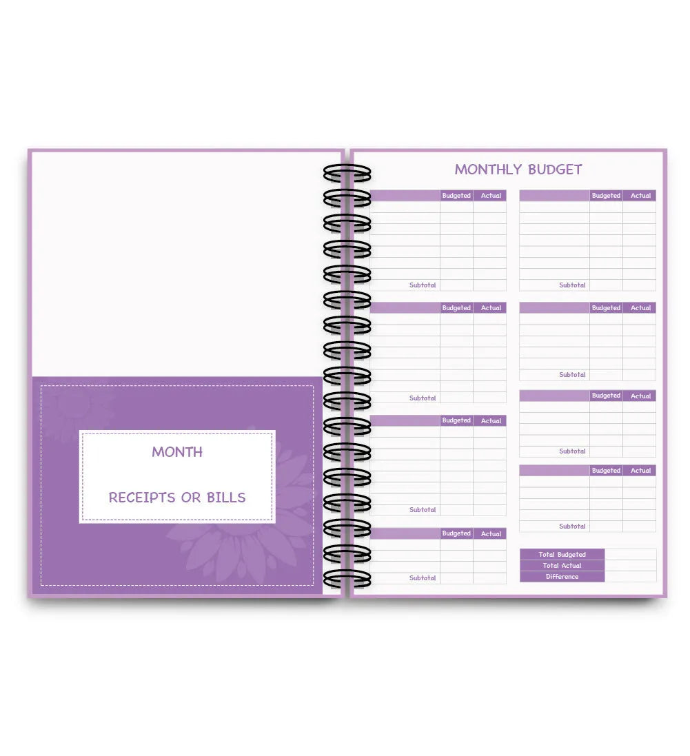 Purple coil-bound budget notebook open showing monthly planning pages with financial stickers and paper clips