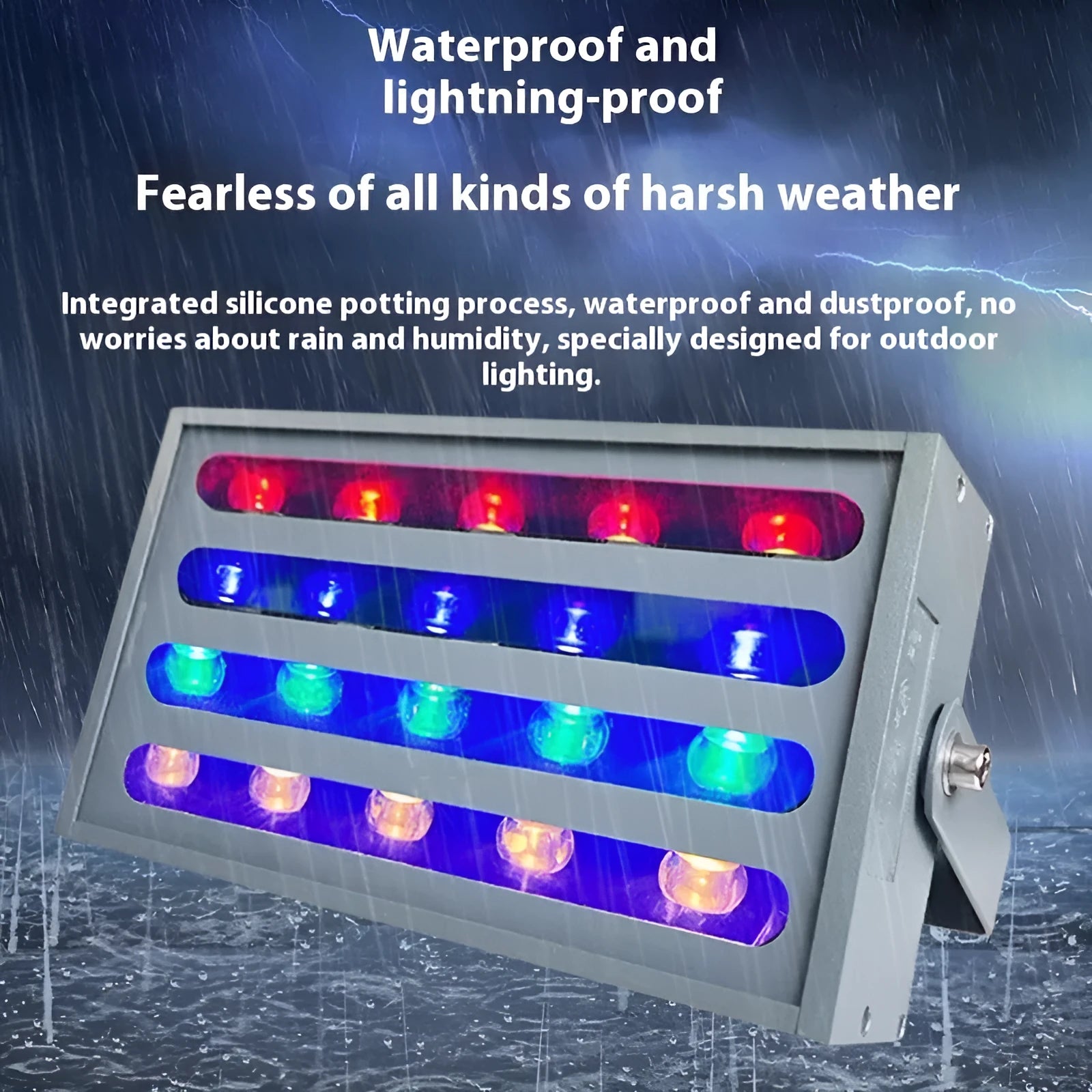 Silver aluminium outdoor LED spotlight projecting multi-coloured light onto trees.