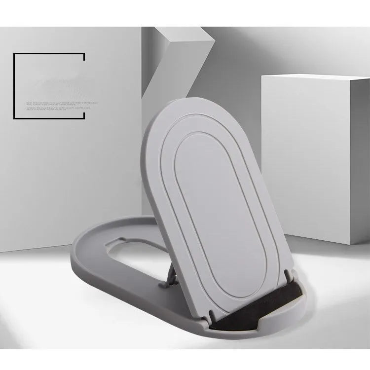 A lazy bracket style mobile phone stand made of plastic, shown in multiple colour options on a wooden desk.