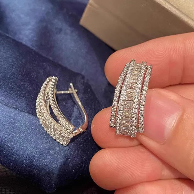 Geometric white gold colour stud earrings with zircon detailing on copper