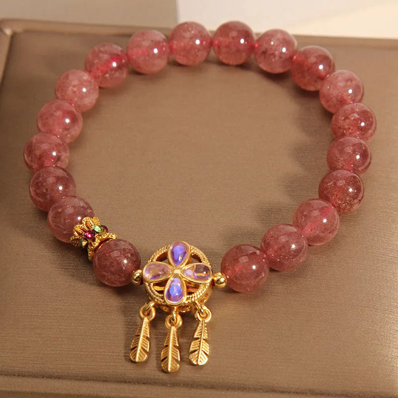 Women's strawberry quartz crystal bracelet with four leaf dream catcher ball pendant in natural rose pink colouration