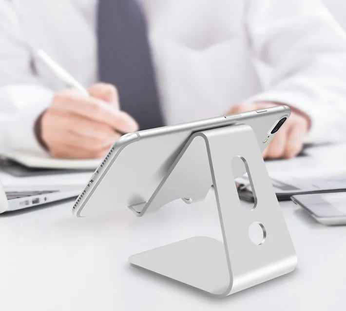 Aluminium universal phone holder in silver colour showing 360-degree rotation feature with tablet mounted
