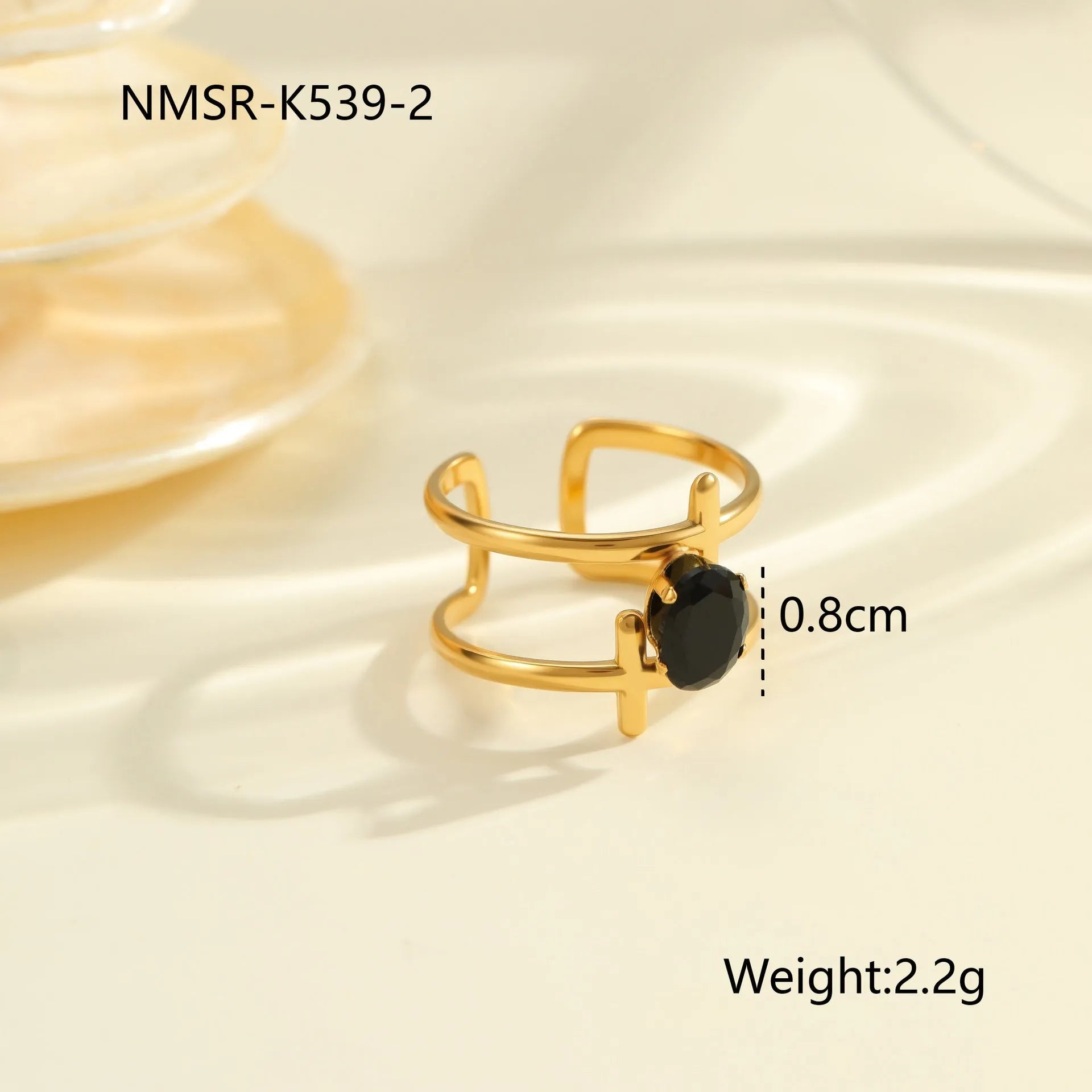 Geometric open mouth titanium steel ring for women on a plain background.