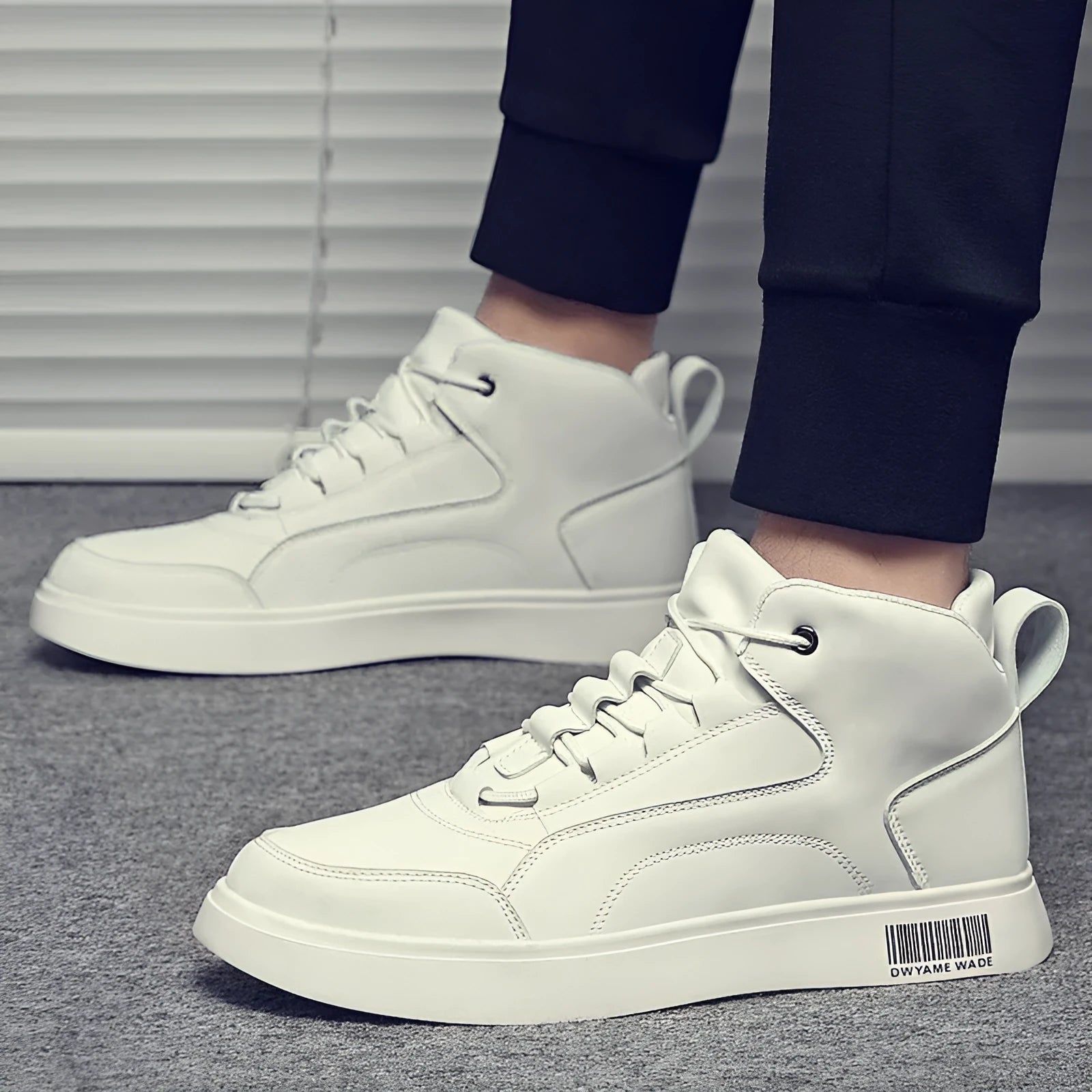 Men's white and black mid-top lace-up casual shoes with a round toe and rubber sole.