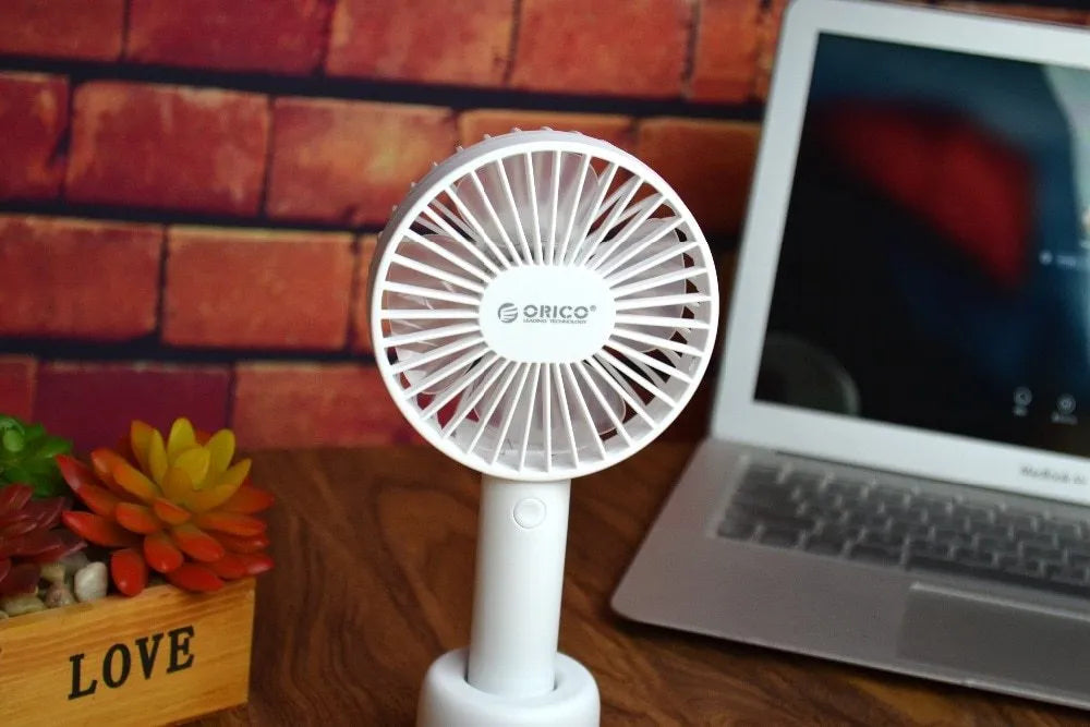 White ORICO FH1 portable USB desk fan with rechargeable battery on a desk