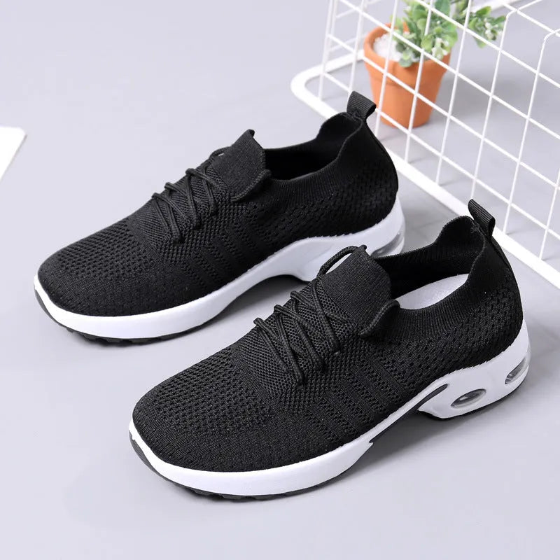 Women's black mesh casual sneakers with round toe and white lace-up front on a soft non-slip sole.