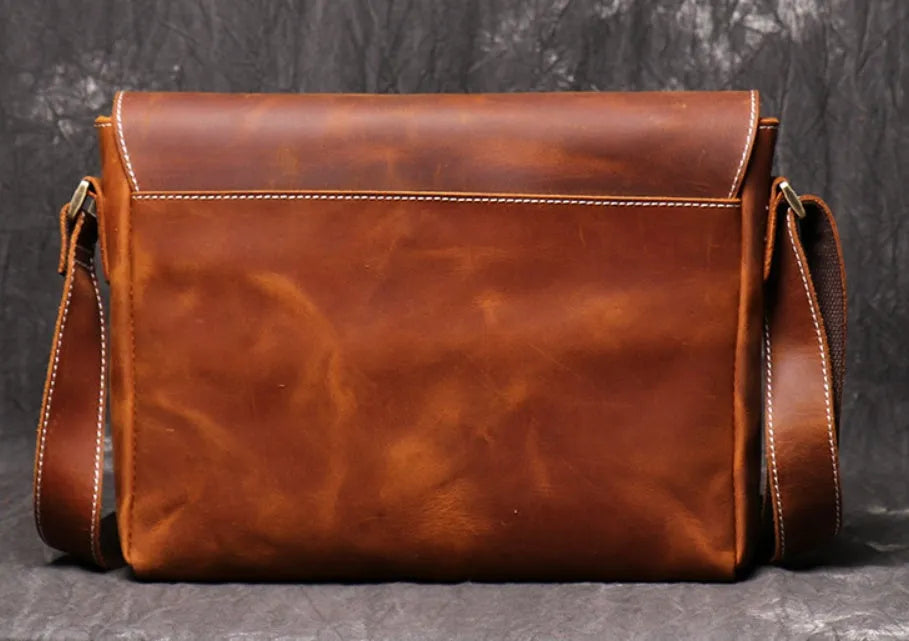 Brown vintage leather men's messenger bag with a flap opening and an adjustable shoulder strap.