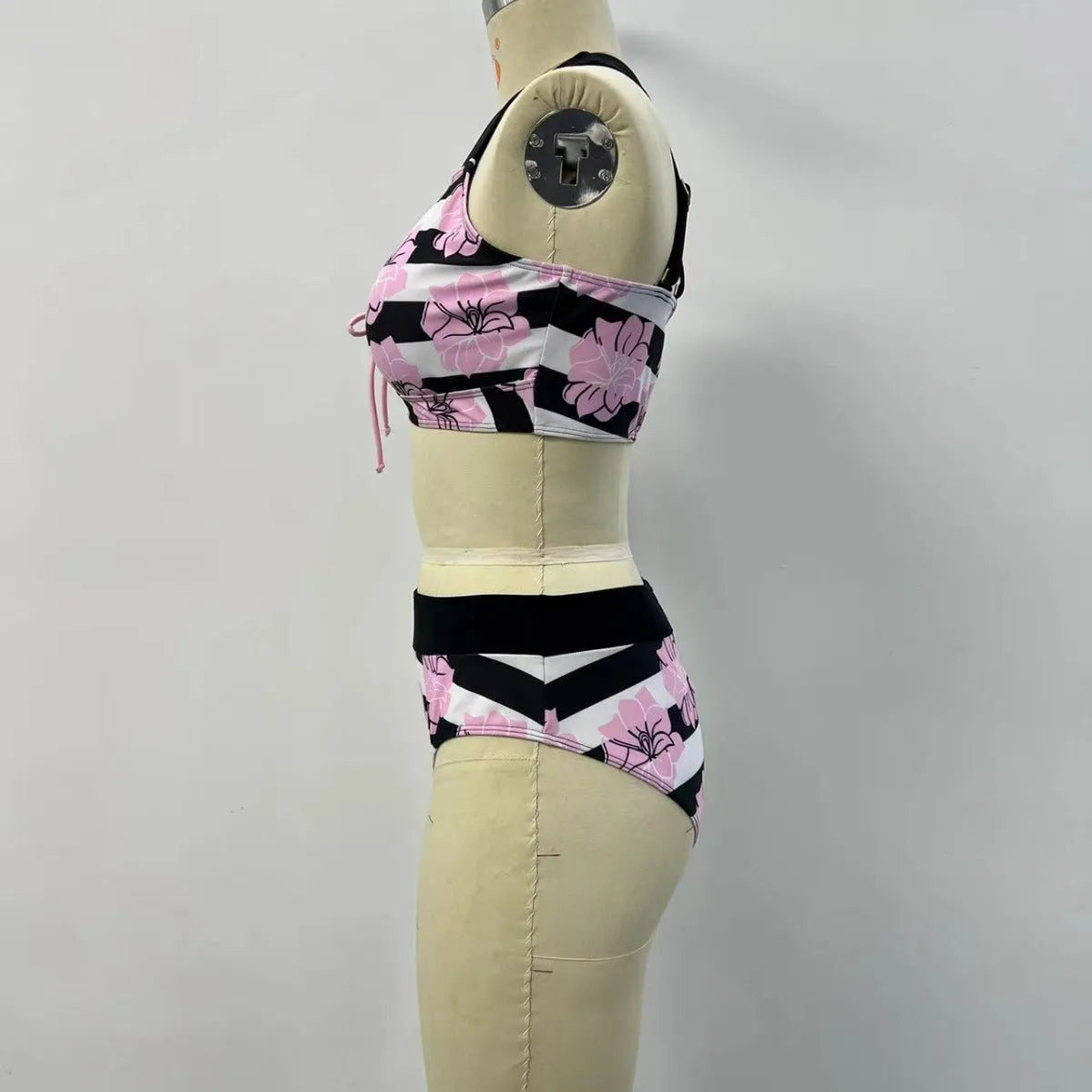 Black women's printed split bikini with high-waisted brief for belly coverage.
