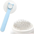Blue self-cleaning cat brush with a rubber handle and round-tipped metal pins.