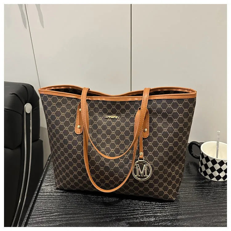 Structured black PU shoulder bag with sewing thread detail and a polyester lining.