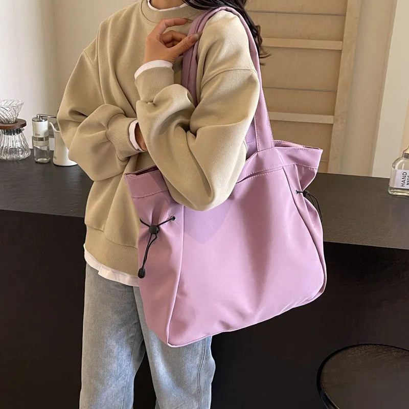Soft oxford cloth folding commuter tote bag in street style, shown in black, grey, brown, and purple colours.