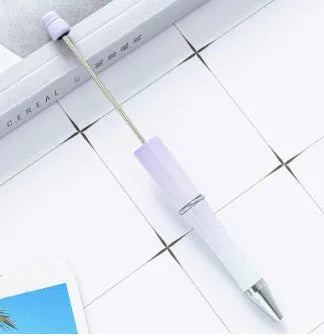 Creative ballpoint pen with multicoloured spinning plastic beads on a steel wire frame.