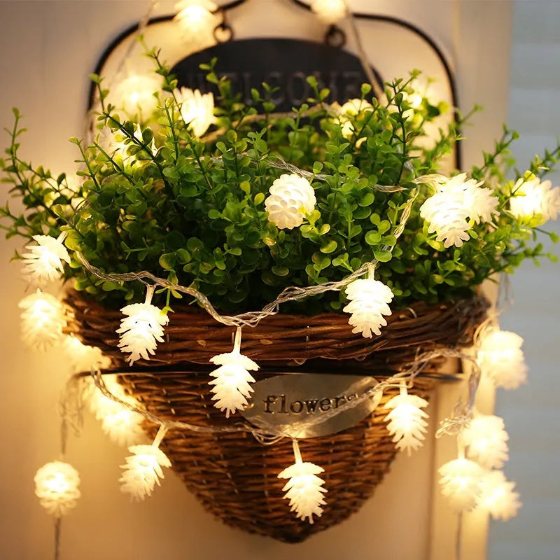 Warm white LED pine cone fairy lights on a string, powered by batteries for cord-free decoration.