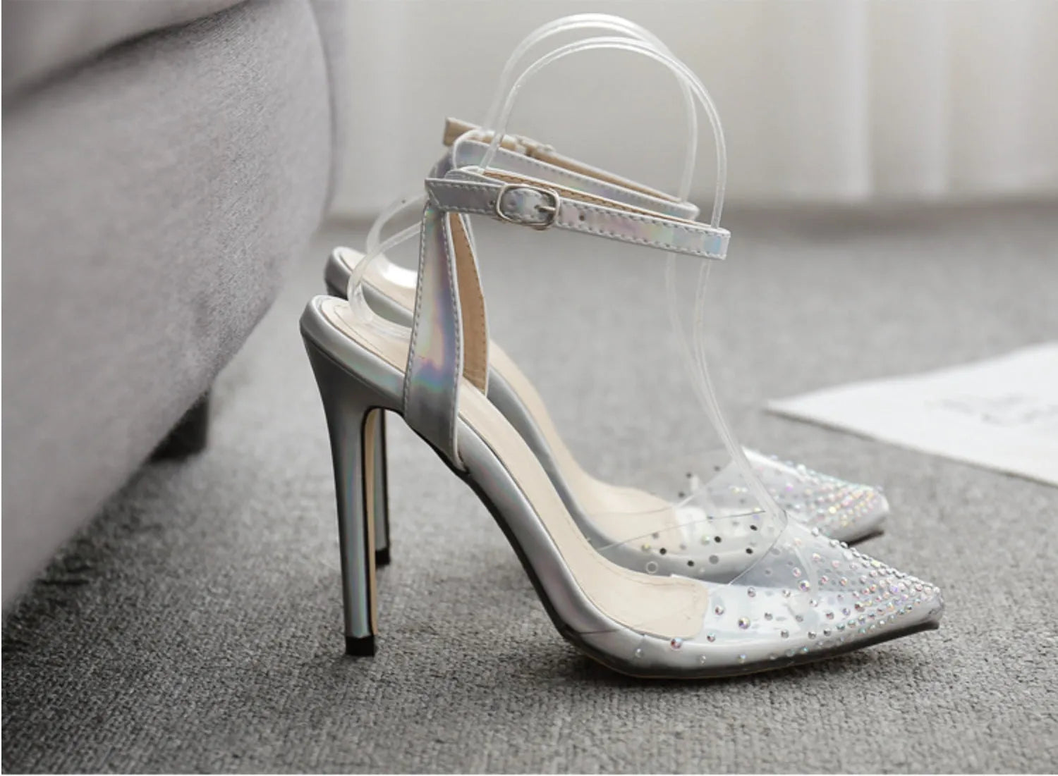 Women's pointed toe diamond sandals with a clear stiletto heel on a white background.