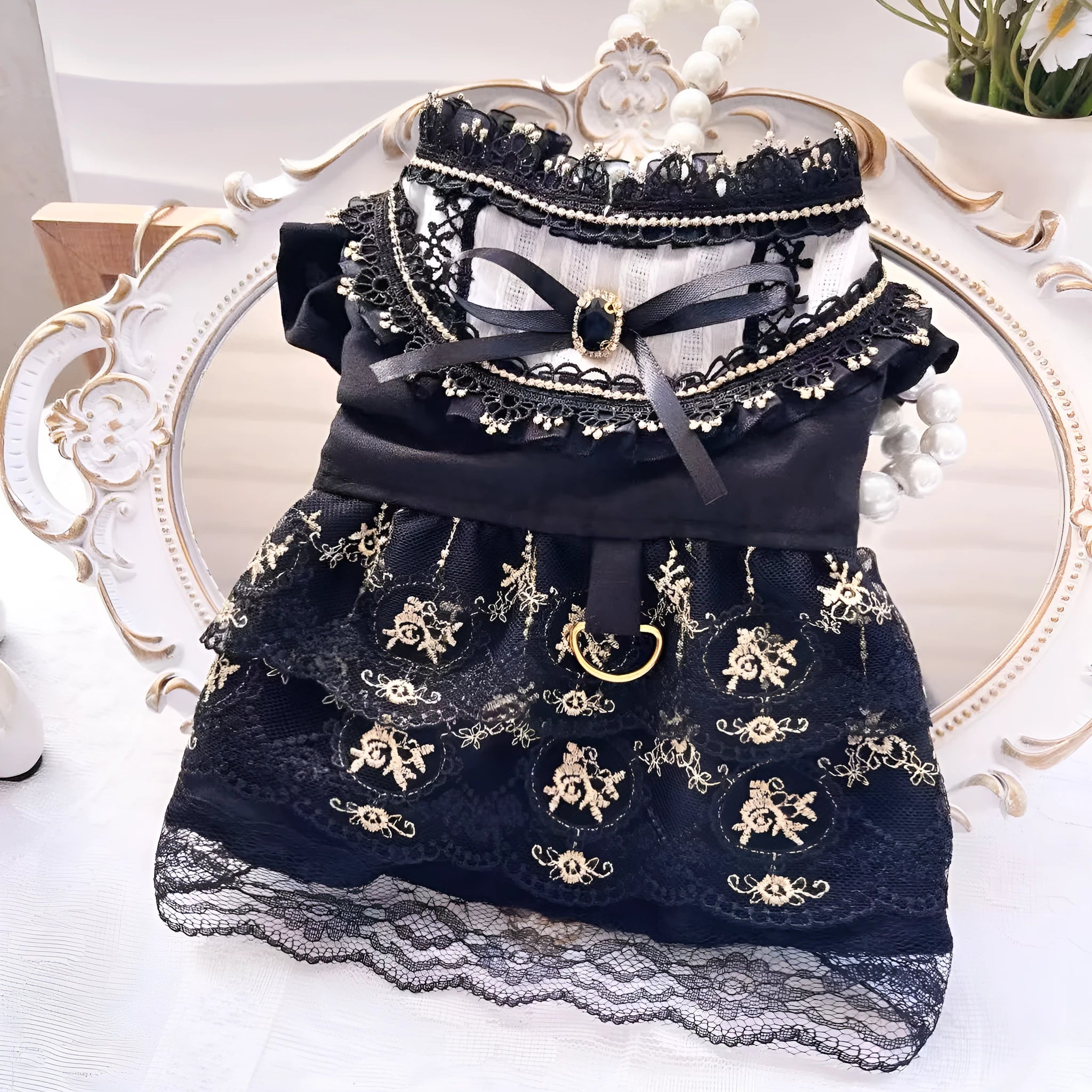 Golden gothic princess style polyester dress for a small dog on a mannequin, showing black skirt detail.