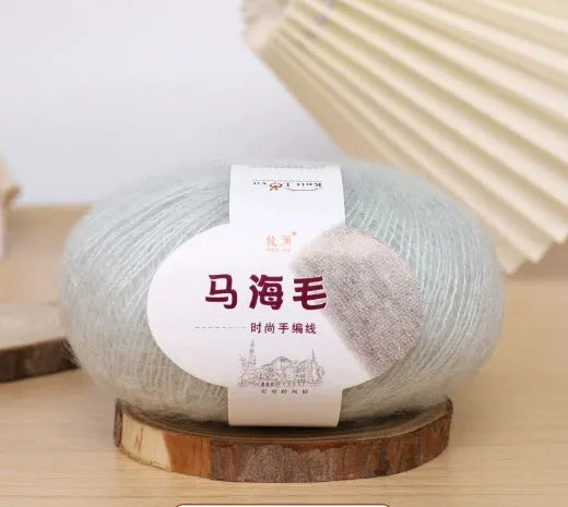 Single ball of mohair yarn in various colours for hand-woven DIY scarf knitting projects
