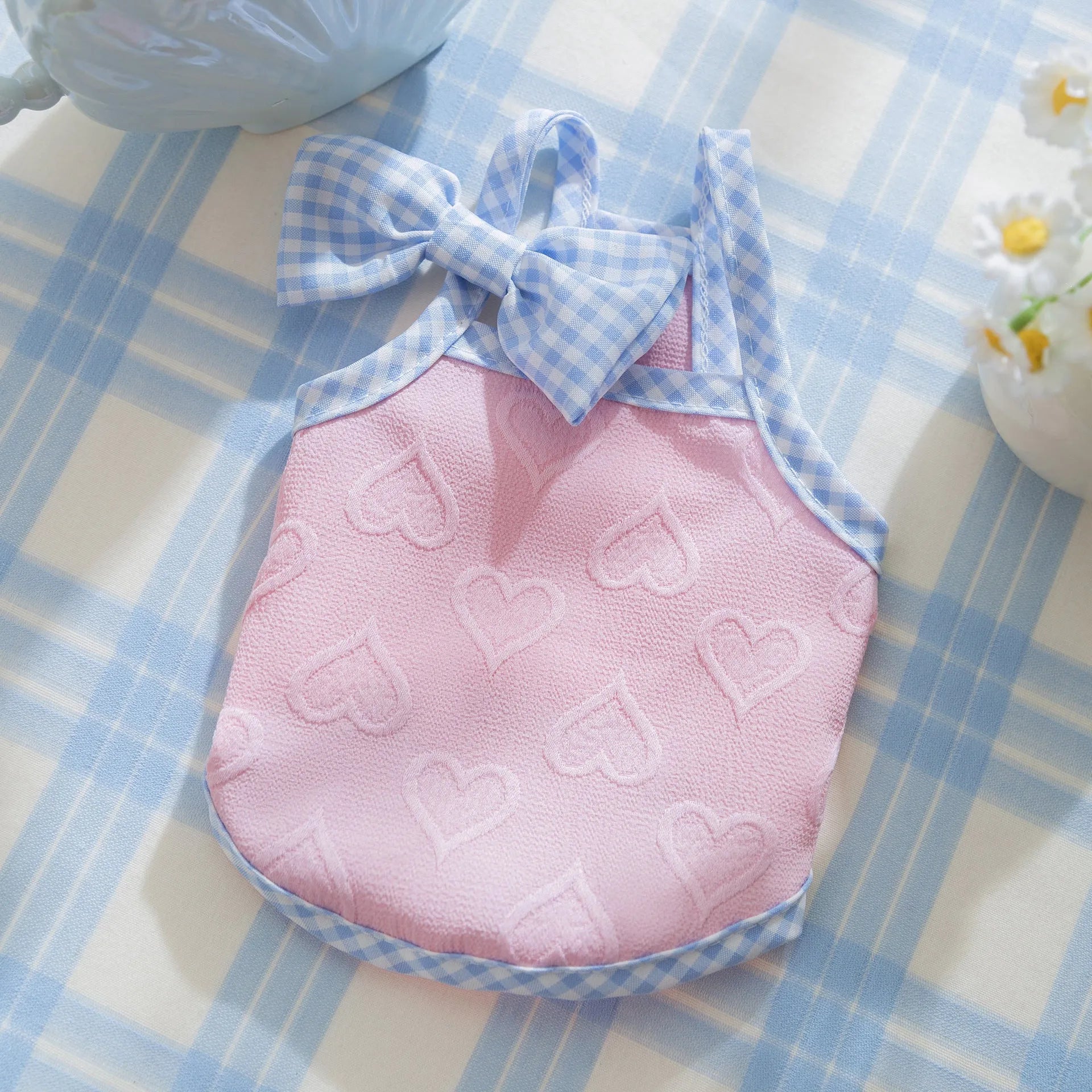 Small dog wearing heart texture elastic vest with bow suspenders in Bondi Blue colour
