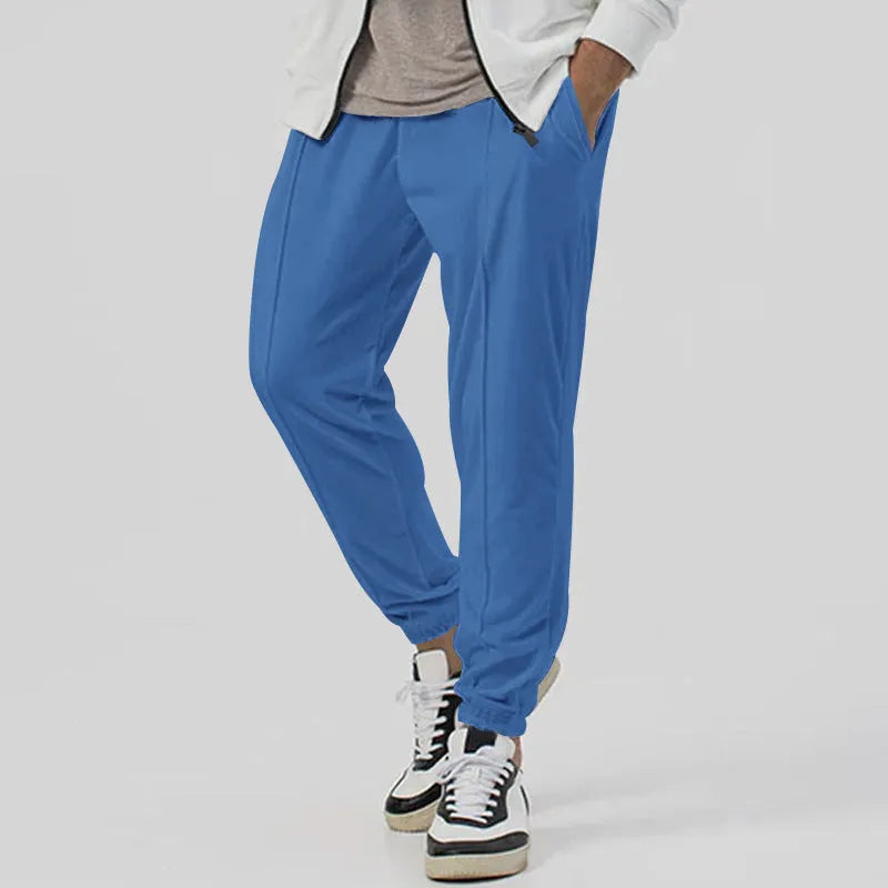 Men's grey casual tapered sweatpants with an elasticated waistband laid flat.